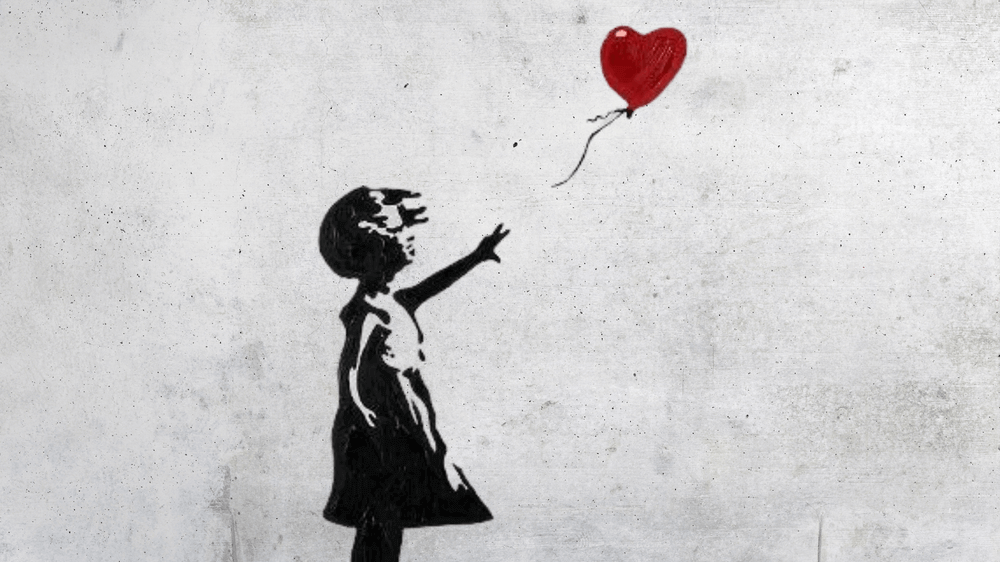 Banksy Grafitti ein Mädchen greift nach einem roten Herz Ballon